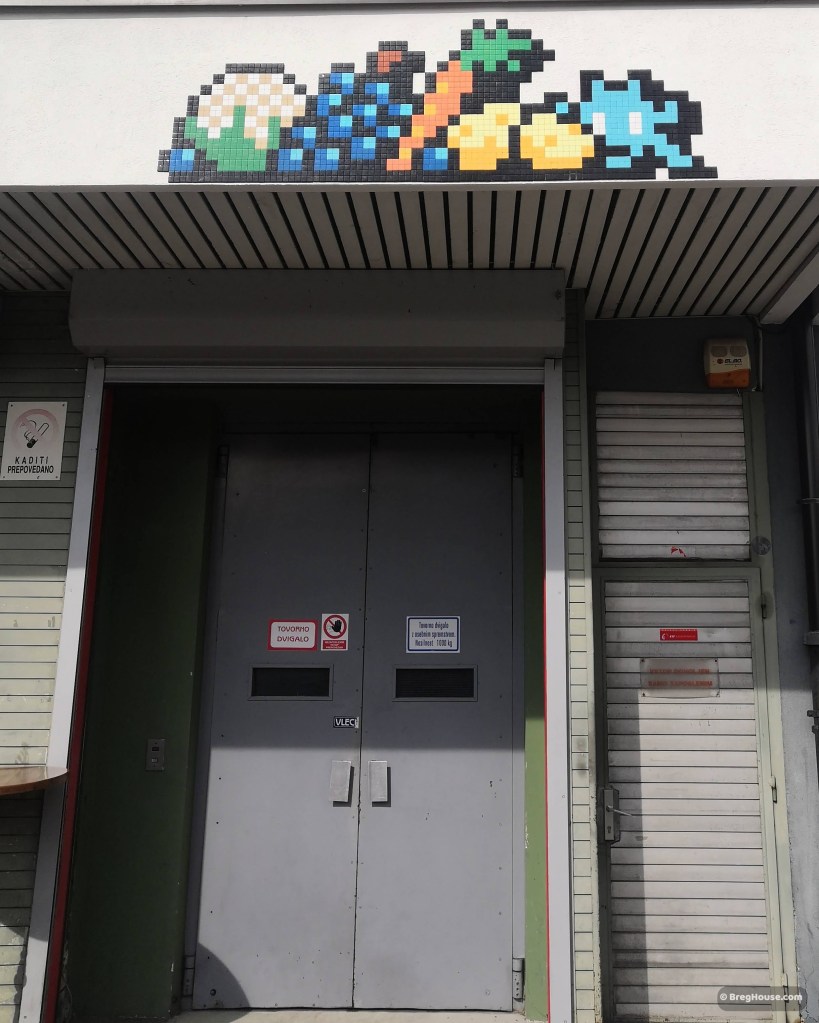 Door in Ljubljana below Invader street art