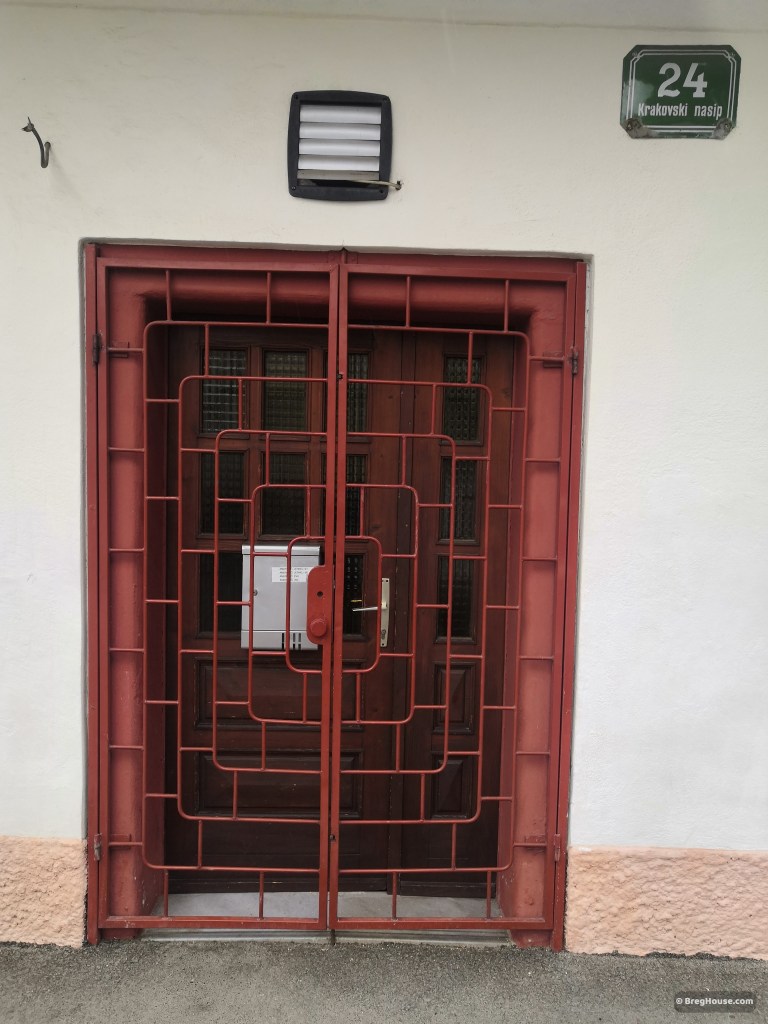 Red metal gates cover door in Ljubljana, Slovenia