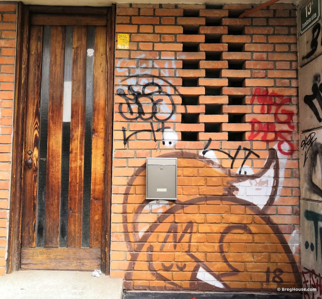 Graffiti fox sits next to door in Ljubljana, Slovenia