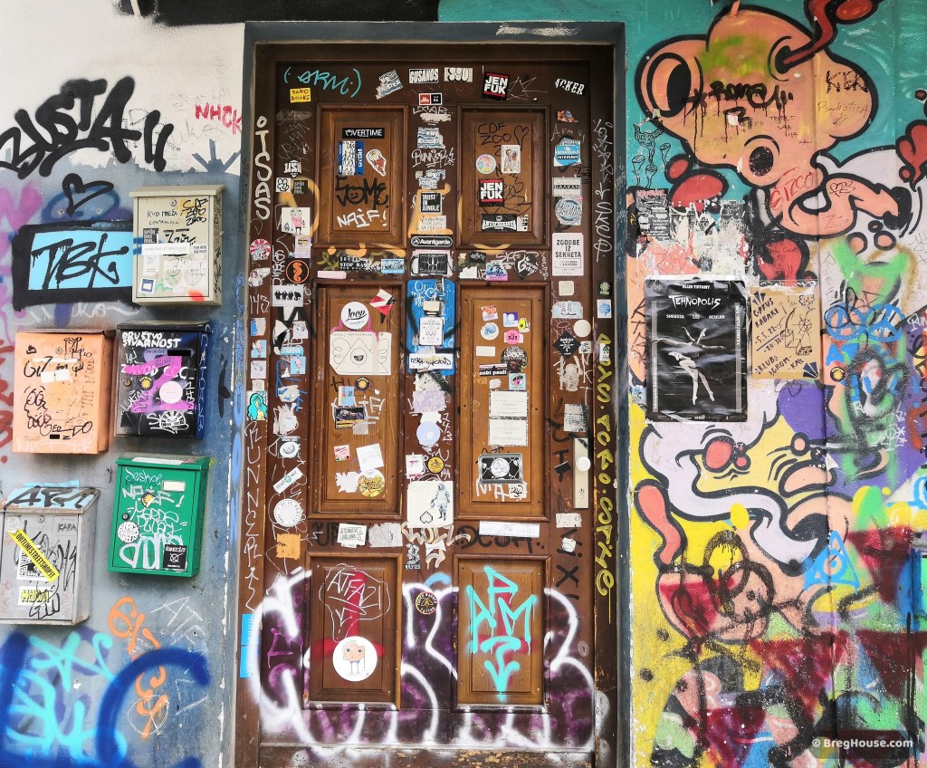 Graffiti and stickers cover door in Metelkova, Ljubljana, Slovenia