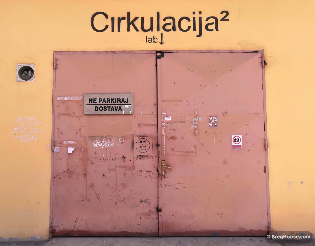 Large, red, metal door in Ljubljana, Slovenia